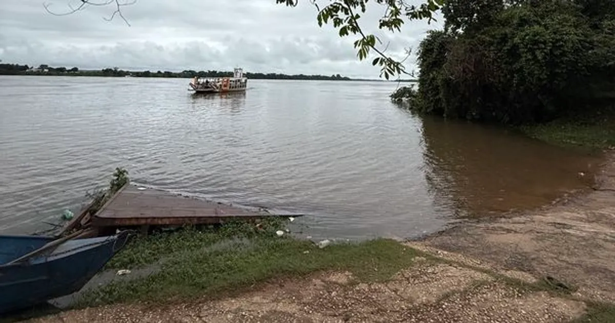 Agente da Defesa Civil de Imperatriz monitora o nível do Rio Tocantins com equipamento de medição, em um dia nublado.
