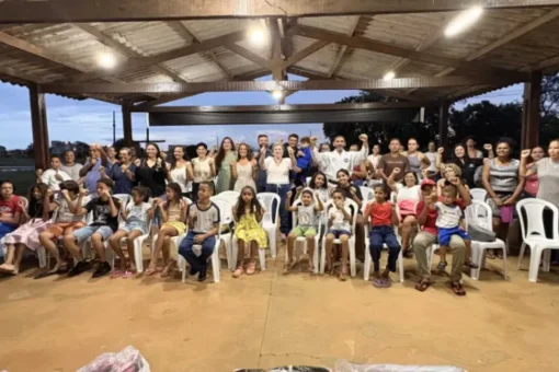 Crianças e adolescentes praticando artes marciais em aula inaugural na Capela Nossa Senhora das Mercês em Palmas, com instrutor.