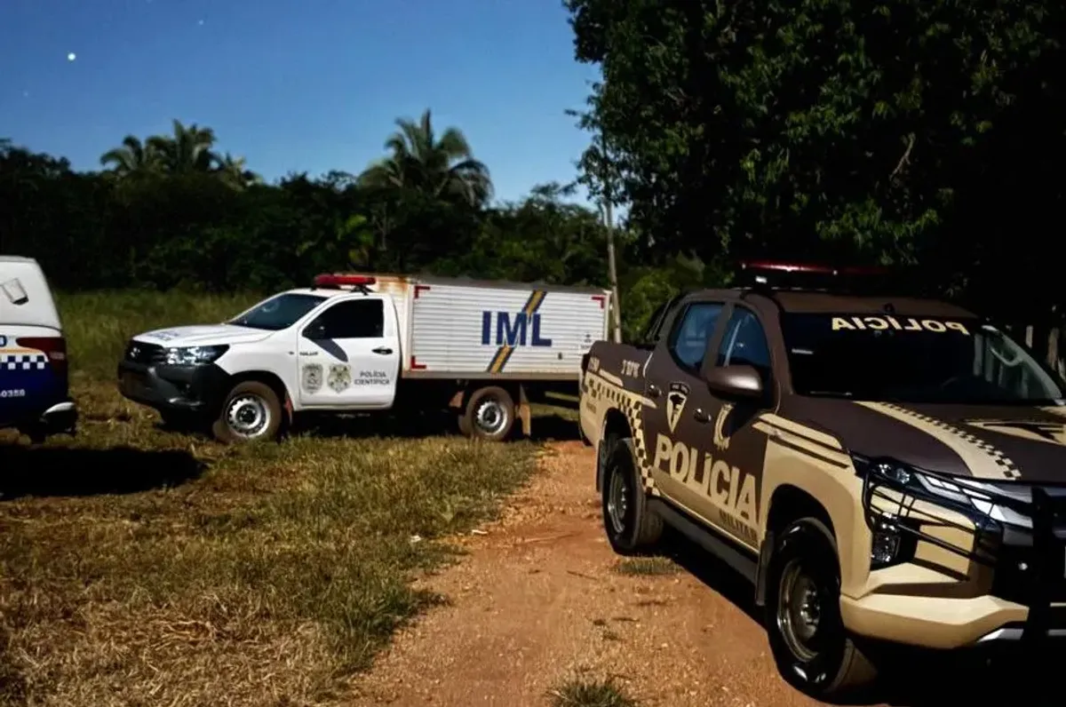 Viaturas policiais em área rural com danos de tiros após confronto fatal em Lajeado, Tocantins.